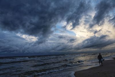 Man on beach against sky