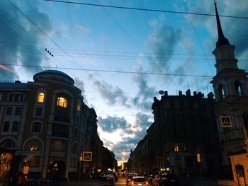 Low angle view of buildings against cloudy sky