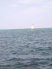 Sailboat on sea against sky