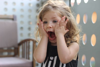 Close-up of shocked girl at home