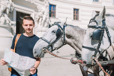 Full length of a young man with horse