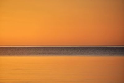 Scenic view of sea against romantic sky at sunset