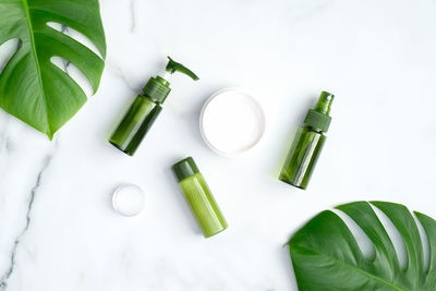 High angle view of green bottles on white background