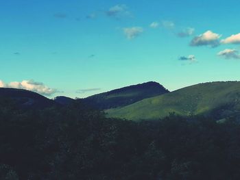 Scenic view of mountains against blue sky