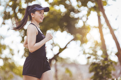 Side view of young woman wearing hat