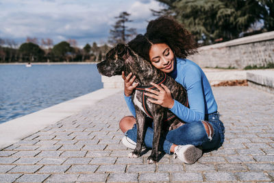 Young woman with dog sitting outdoors