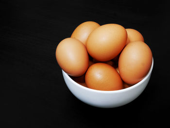 High angle view of eggs in container against black background