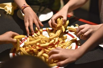 Children grabbing french fries