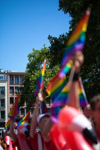 Blurred motion of people against blue sky