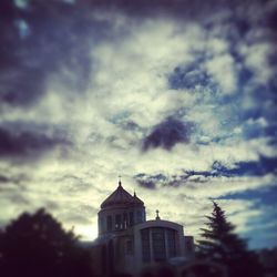 Low angle view of church against cloudy sky