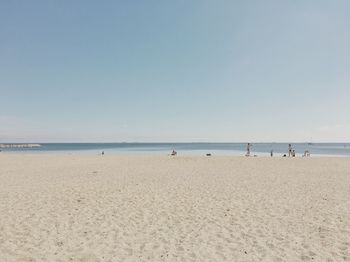 Scenic view of beach against clear blue sky