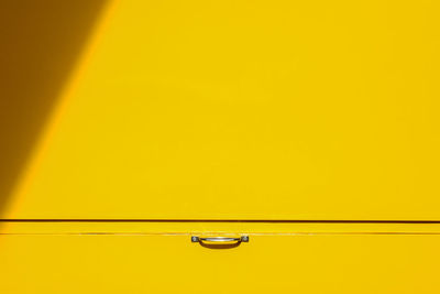 Close-up of yellow car on wall