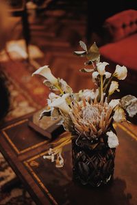 Close-up of wilted flower vase on table