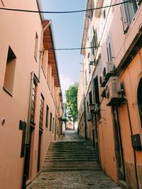 Narrow alley amidst buildings in town