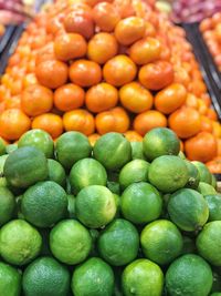 Full frame shot of limes and oranges at market stall