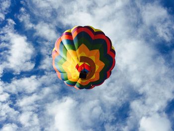 Low angle view of colorful balloons against blue sky