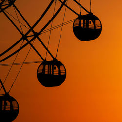 Low angle view of silhouetted ferris wheel