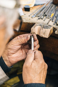 Close-up of hand holding wood