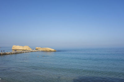 Scenic view of sea against clear blue sky