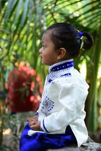 Cute boy wearing traditional clothing at park