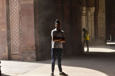 Full length of a man standing against building