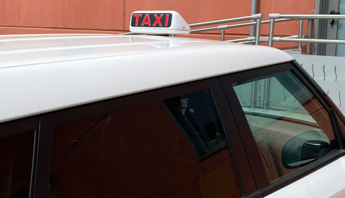 Taxi car waiting for customers. taxi cab sign on top of the car. bologna, italy.