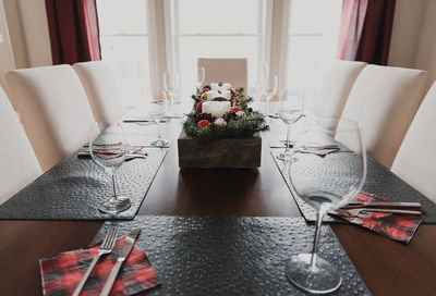 Close up of a dining table set for a christmas holiday dinner.