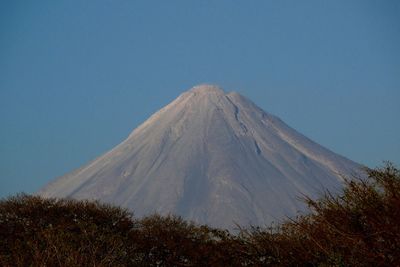 View of volcanic mountain against blue sky