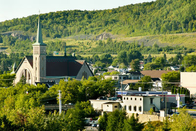 High angle view of trees and buildings in city