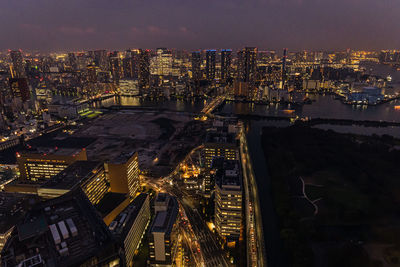 High angle view of illuminated city buildings at night