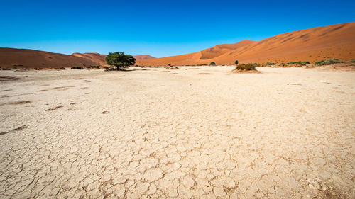 View of desert against blue sky