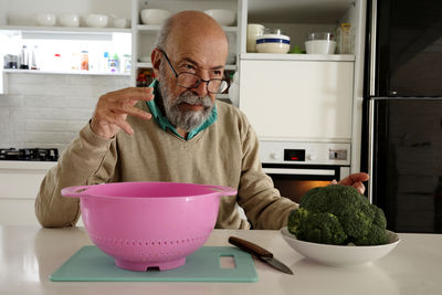 Portrait of young man working in kitchen