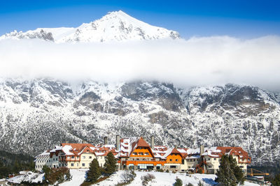 Houses against snowcapped mountains during winter