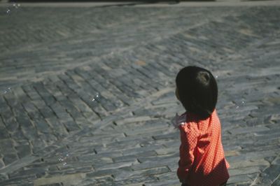 High angle view of girl standing on street