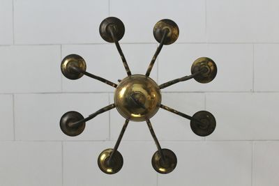 Low angle view of electric lamp hanging on ceiling