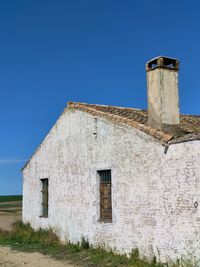 Low angle view of building against clear blue sky