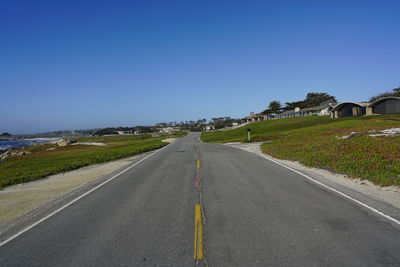 Empty road against clear sky