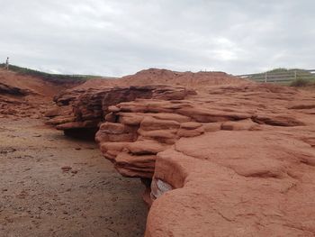 Rock formations on landscape against sky