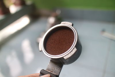 Cropped hand holding coffee