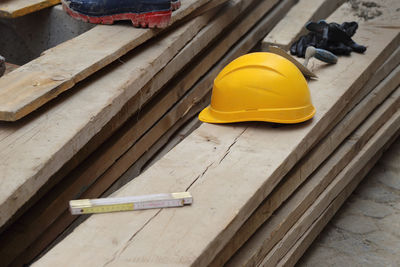 Yellow working on wood at construction site