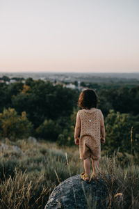 Rear view of woman looking at sea against sky