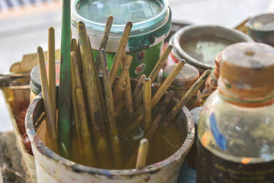 Close-up of paintbrushes in container at workshop