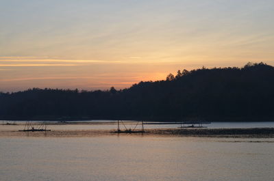 Scenic view of beach against sky during sunset