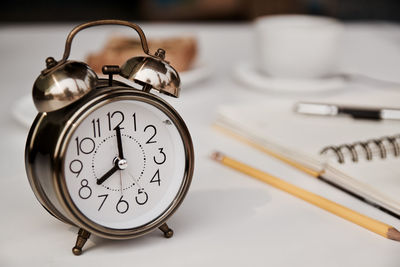 Close-up of clock on table