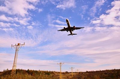 Low angle view of airplane flying in sky