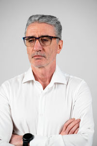 Mature man standing against white background
