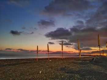 Scenic view of beach against cloudy sky