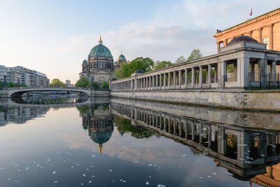 Reflection of berliner dom by spree river against sky