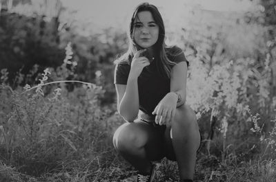 Young woman sitting on field