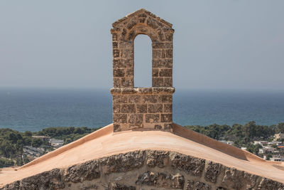 Gazebo in sea against clear sky